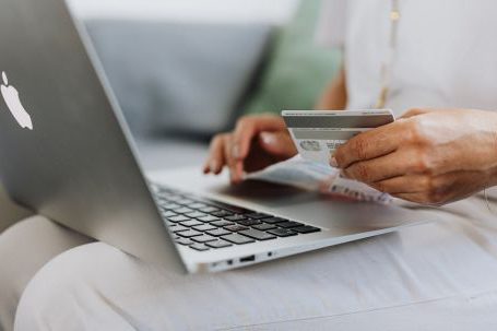 Online Shopping - Person Using a Macbook and Holding a Credit Card