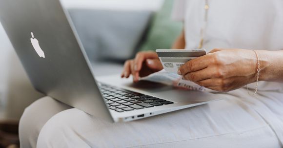 Online Shopping - Person Using a Macbook and Holding a Credit Card