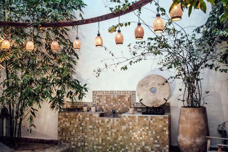 Authentic Brands - Traditional oriental hammam pool on exotic resort spa terrace decorated with lush plants and stylish lanterns