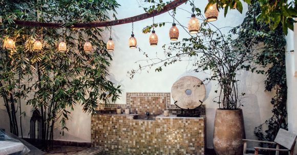 Authentic Brands - Traditional oriental hammam pool on exotic resort spa terrace decorated with lush plants and stylish lanterns