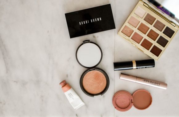 Cosmetics - photo of assorted makeup products on gray surface