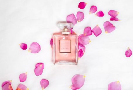 Perfume - perfume bottle with pink petals
